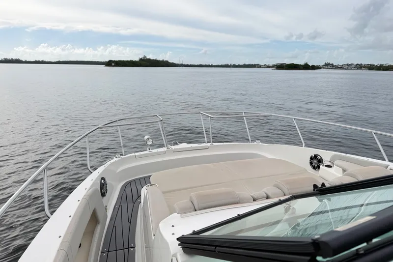Slide: The Image of 2020 Sea Ray Sundancer 320 Coupe Outboard cruising on calm waters under a cloudy sky. - 27
