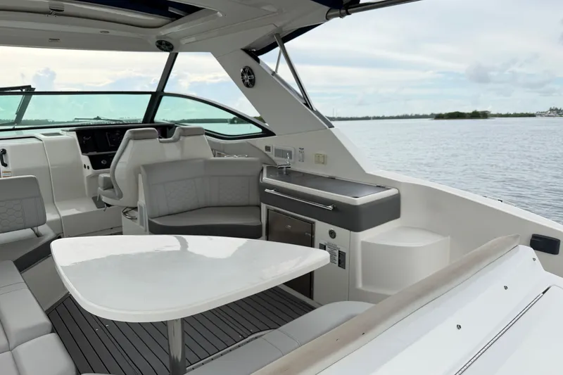 Slide: The Image of Interior of 2020 Sea Ray Sundancer 320 Coupe Outboard, featuring sleek seating and modern amenities. - 18