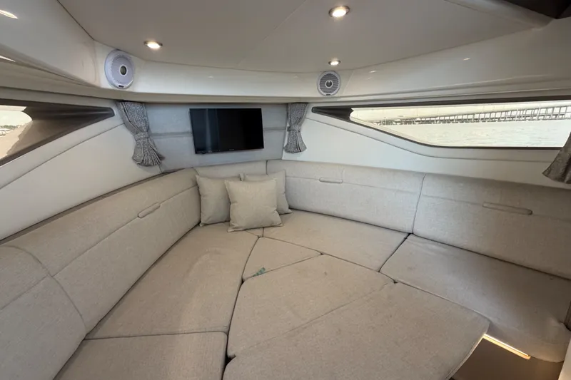 Slide: The Image of Luxurious interior of 2020 Sea Ray Sundancer 320 Coupe Outboard with plush seating and TV. - 38