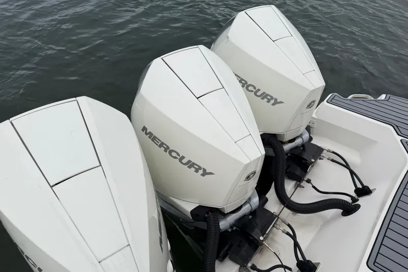 Slide: The Image of 2020 Sea Ray Sundancer 320 Coupe Outboard with triple Mercury engines on water. - 47