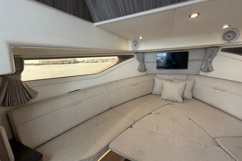 Slide: The Image of Interior of 2020 Sea Ray Sundancer 320 Coupe Outboard with cozy seating and window view. - 37