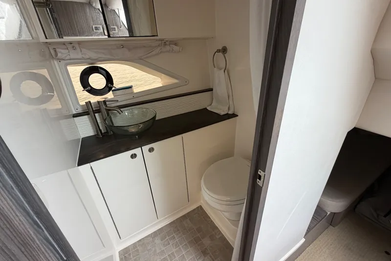 Slide: The Image of 2020 Sea Ray Sundancer 320 Coupe Outboard bathroom with modern sink and toilet. - 40