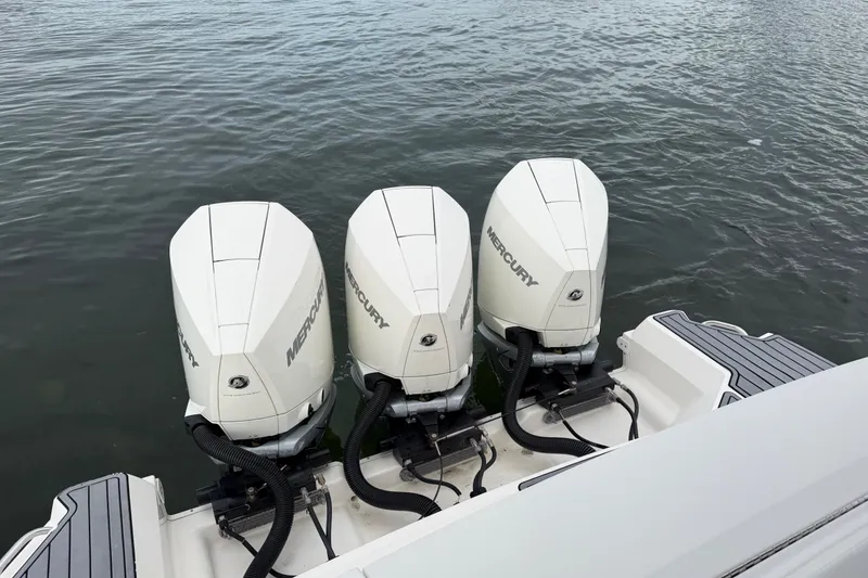 Slide: The Image of 2020 Sea Ray Sundancer 320 Coupe Outboard with triple Mercury engines on water. - 46