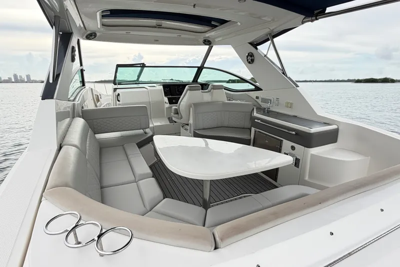 Slide: The Image of 2020 Sea Ray Sundancer 320 Coupe Outboard interior with luxurious seating and table. - 11