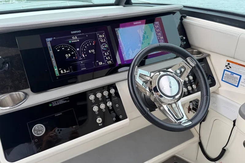 Slide: The Image of Dashboard of 2020 Sea Ray Sundancer 320 Coupe Outboard with navigation screens and controls. - 7