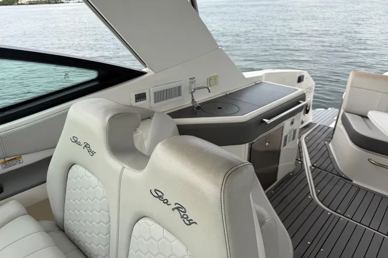 Slide: The Image of 2020 Sea Ray Sundancer 320 Coupe Outboard interior with luxurious seating and kitchenette. - 13