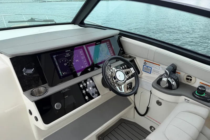 Slide: The Image of Cockpit of 2020 Sea Ray Sundancer 320 Coupe Outboard with modern navigation displays. - 8