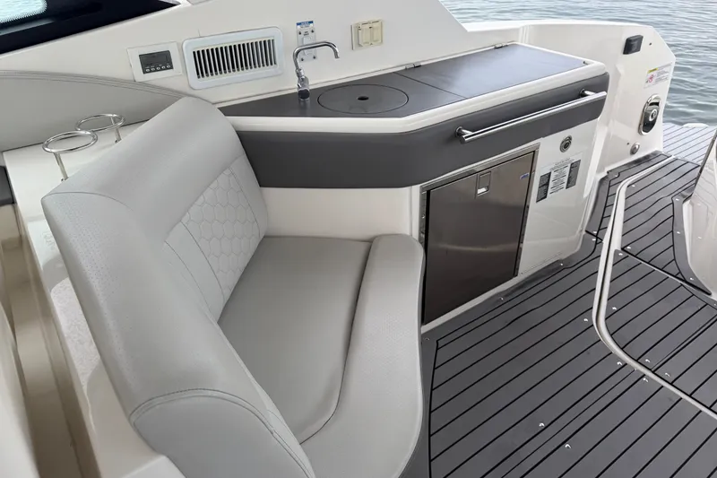 Slide: The Image of 2020 Sea Ray Sundancer 320 Coupe Outboard interior with seating and kitchenette. - 15