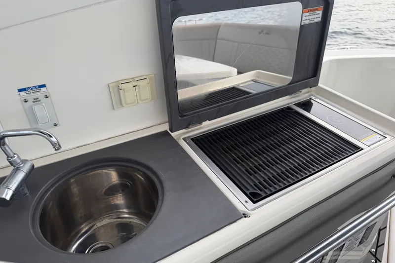 Slide: The Image of Outdoor kitchen on 2020 Sea Ray Sundancer 320 Coupe Outboard with sink and grill. - 22