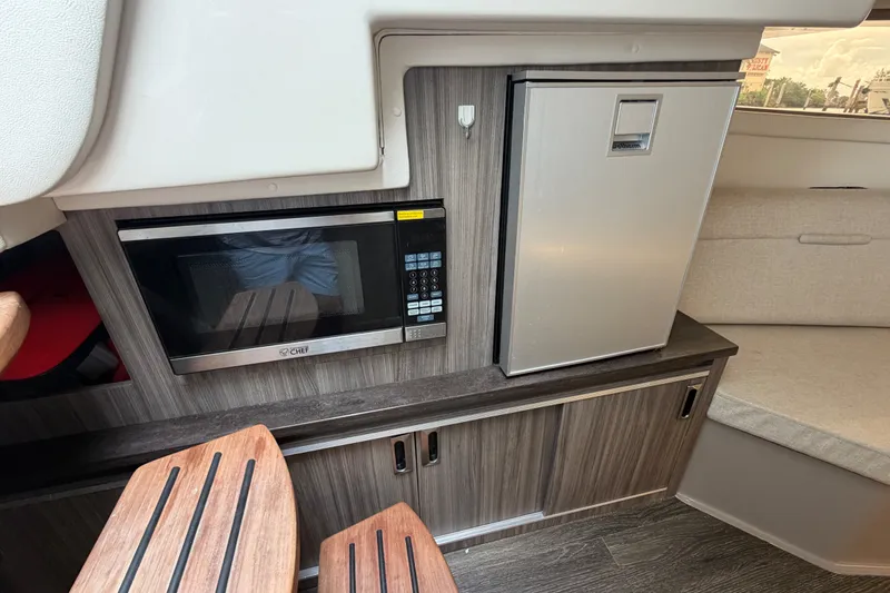 Slide: The Image of 2020 Sea Ray Sundancer 320 Coupe Outboard interior with microwave and compact fridge. - 41