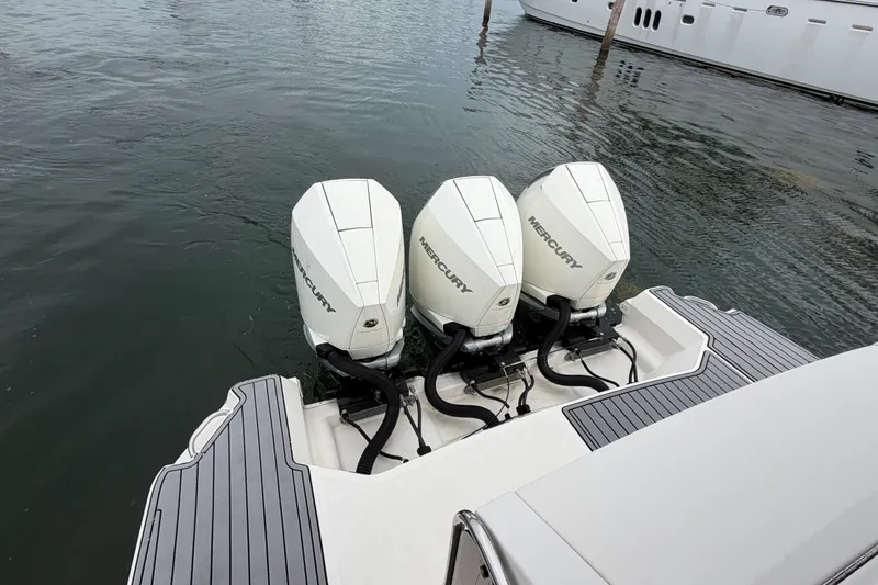 Slide: The Image of Triple Mercury outboard engines on a 2020 Sea Ray Sundancer 320 Coupe, docked in water. - 49