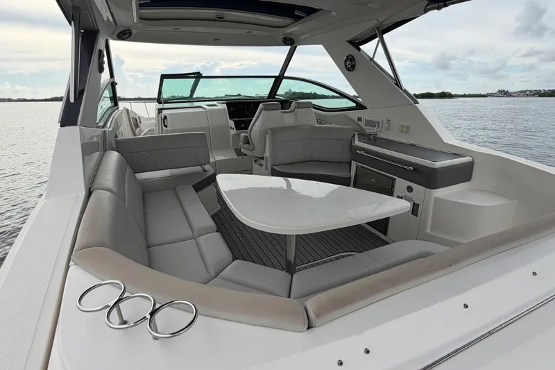 Slide: The Image of Luxurious interior of 2020 Sea Ray Sundancer 320 Coupe Outboard, featuring elegant seating and table. - 12