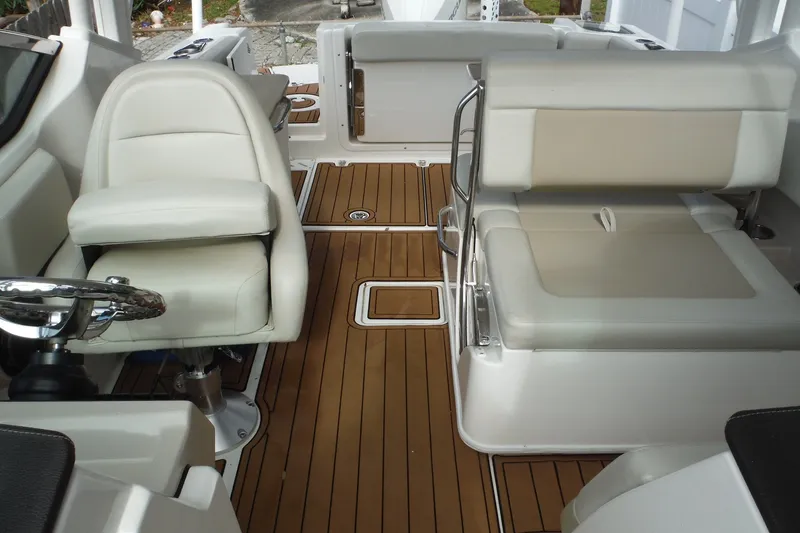 Slide: The Image of 2021 Boston Whaler 240 Vantage interior with white seating and teak flooring. - 14