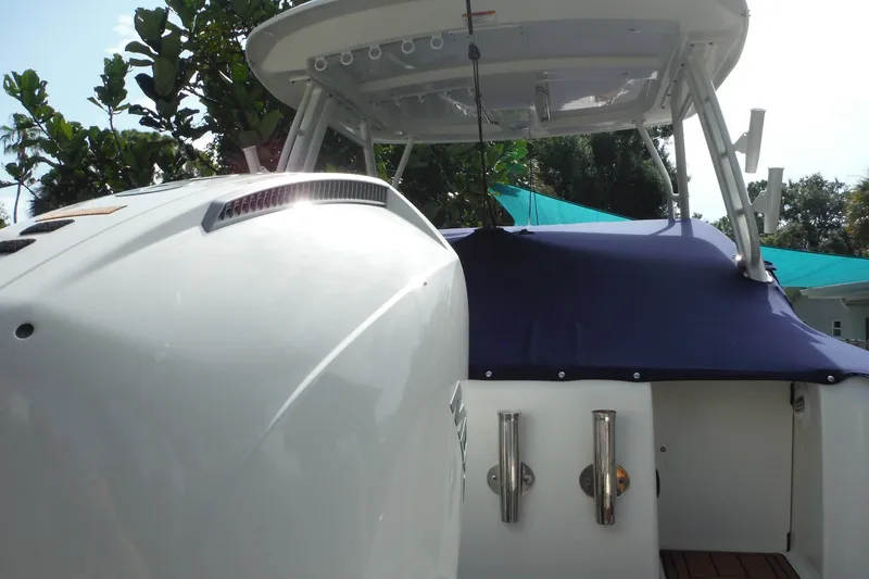 Slide: The Image of 2021 Boston Whaler 240 Vantage boat with blue cover and sleek design in a sunny setting. - 52