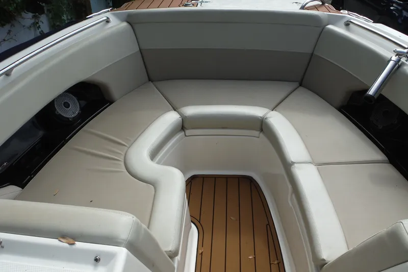 Slide: The Image of 2021 Boston Whaler 240 Vantage boat interior with cushioned seating and teak flooring. - 13