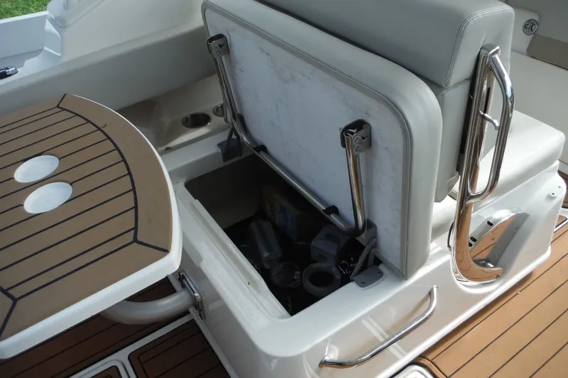 Slide: The Image of 2021 Boston Whaler 240 Vantage boat seat storage compartment open, showcasing interior space. - 28