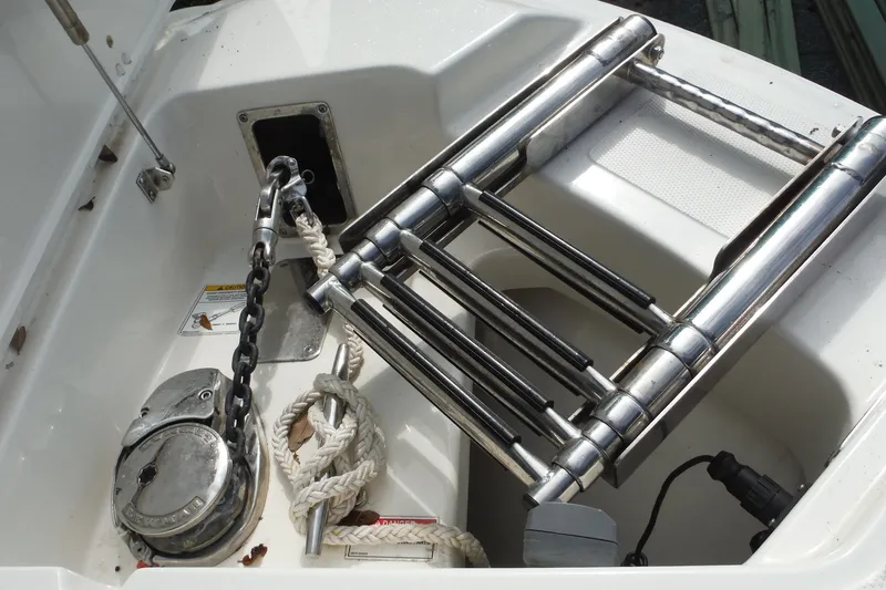 Slide: The Image of 2021 Boston Whaler 240 Vantage boat anchor and ladder storage compartment. - 32