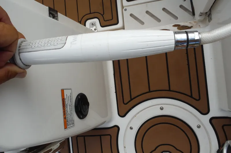 Slide: The Image of Close-up of a 2021 Boston Whaler 240 Vantage boat deck with a white handle. - 36