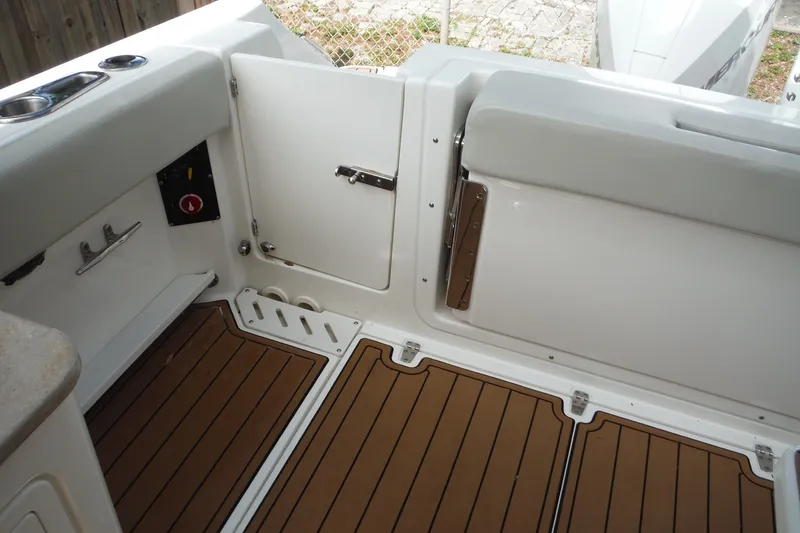 Slide: The Image of 2021 Boston Whaler 240 Vantage boat interior with teak flooring and storage compartments. - 42