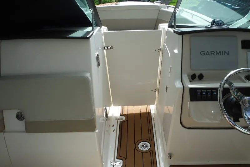 Slide: The Image of 2021 Boston Whaler 240 Vantage cockpit with Garmin navigation system and teak flooring. - 41