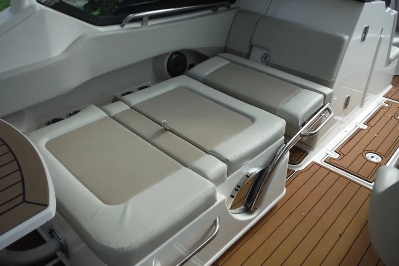 Slide: The Image of Interior seating of 2021 Boston Whaler 240 Vantage with beige cushions and teak flooring. - 18
