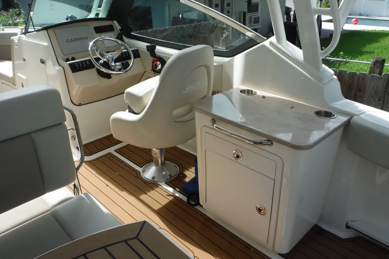 Slide: The Image of 2021 Boston Whaler 240 Vantage boat interior with helm, seating, and storage. - 43
