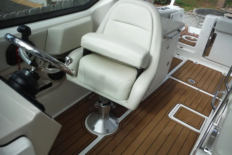 Slide: The Image of Interior of a 2021 Boston Whaler 240 Vantage boat with a sleek helm and seating. - 16