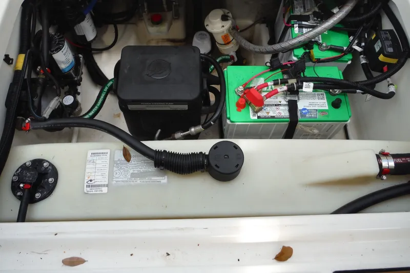 Slide: The Image of Engine compartment of a 2021 Boston Whaler 240 Vantage, featuring batteries and wiring. - 29