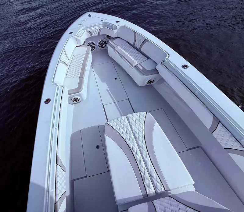 Slide: The Image of 2024 Contender 39 ST boat interior with luxurious seating and sleek design on the water. - 26