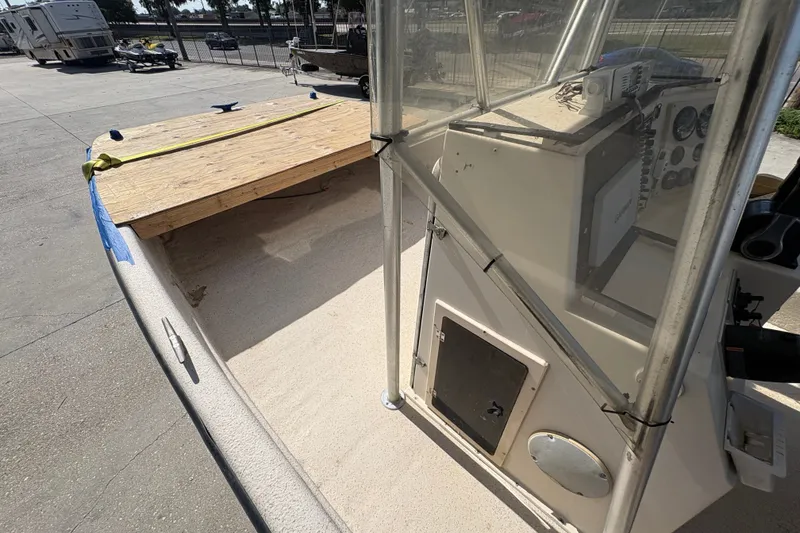 Slide: The Image of 2019 Carolina Skiff 24 DLX boat interior with console and wooden deck. - 17