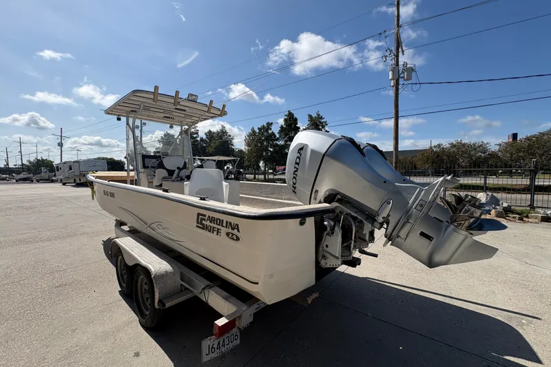 Slide: The Image of 2019 Carolina Skiff 24 DLX boat on trailer with Honda outboard motor. - 6