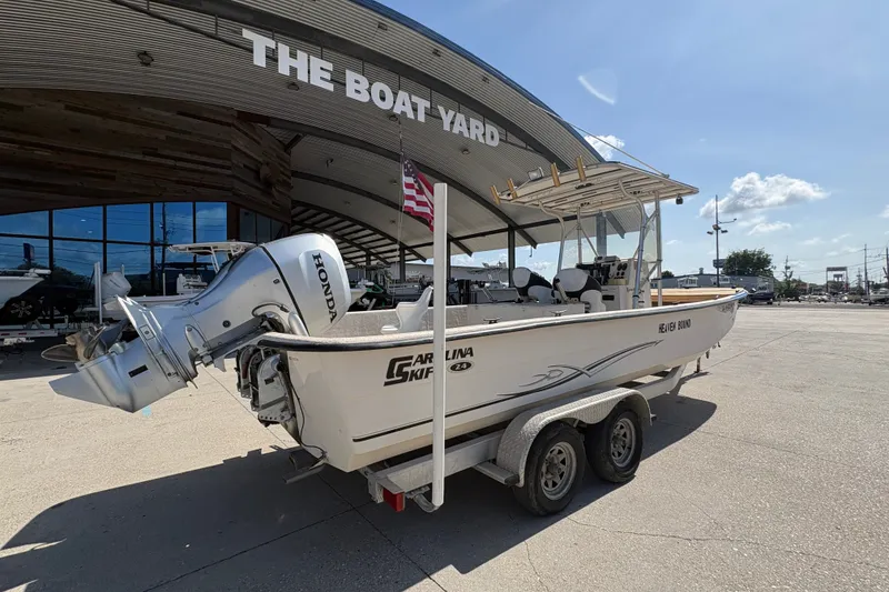 Slide: The Image of 2019 Carolina Skiff 24 DLX boat on trailer at The Boat Yard dealership. - 4