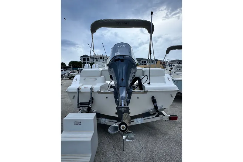Slide: The Image of 2027 Key West 189 FS boat with outboard motor, parked on a trailer. - 13