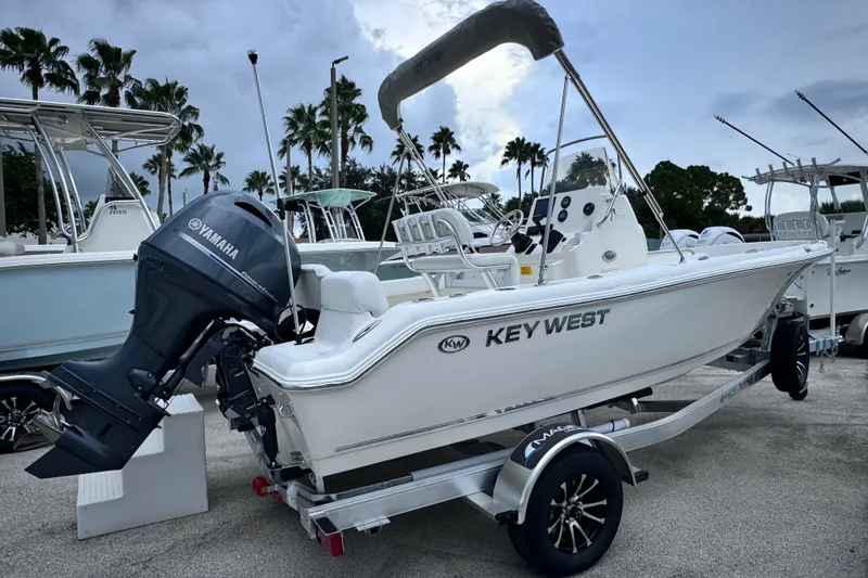 Slide: The Image of 2027 Key West 189 FS boat with Yamaha engine on trailer, parked outdoors. - 14