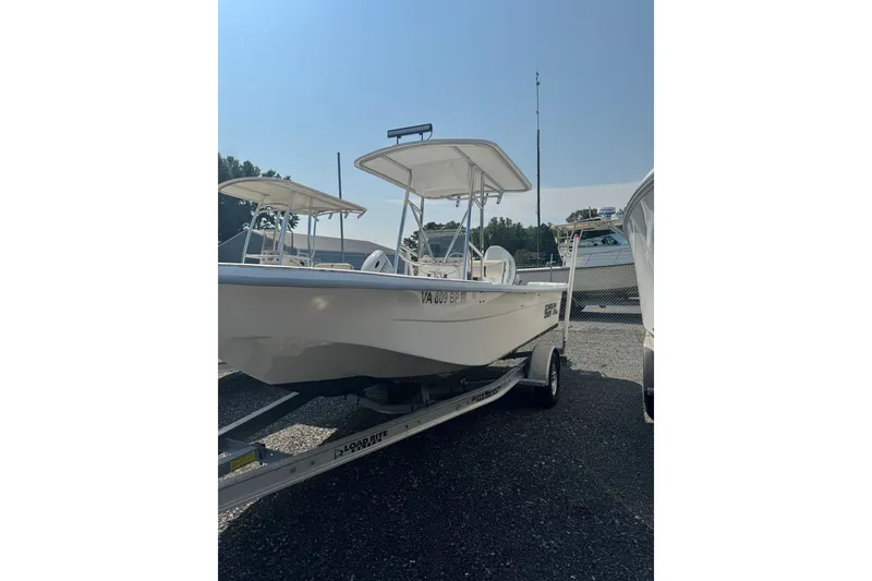 The Image of 2009 Carolina Skiff 218 DLV boat on trailer in sunny outdoor setting. - 1