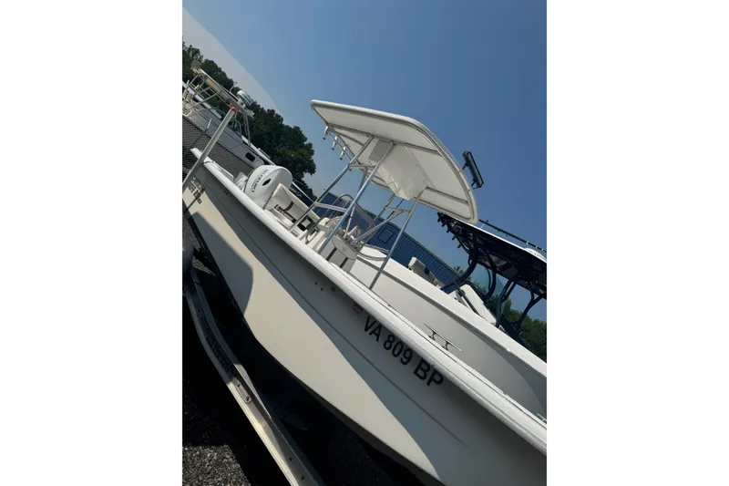 Slide: The Image of 2009 Carolina Skiff 218 DLV boat on trailer, sunny day, marina background. - 15