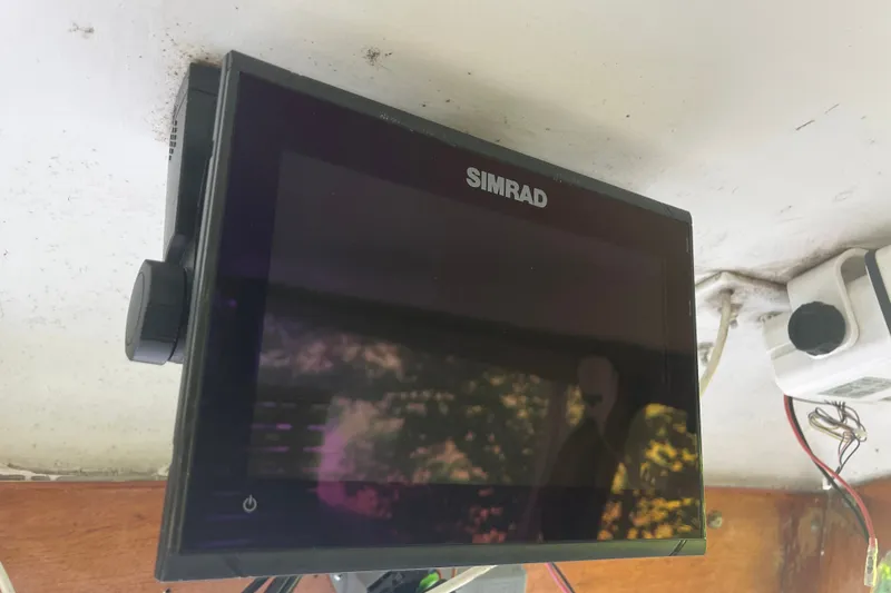 Slide: The Image of Simrad marine display on a 1970 Dyer 29 boat, mounted under a cabin roof. - 22