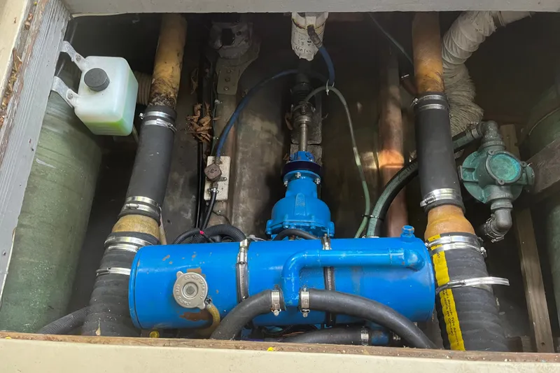 Slide: The Image of Engine compartment of a 1970 Dyer 29 boat with visible hoses and machinery. - 14
