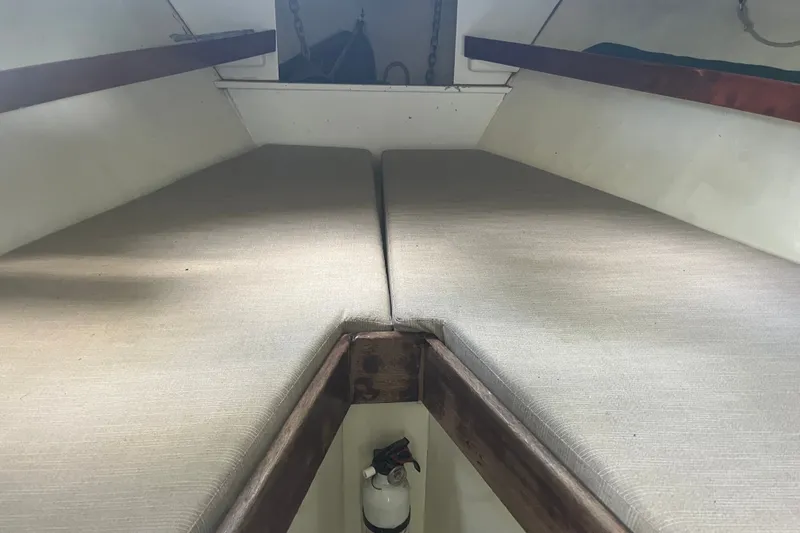 Slide: The Image of Interior cabin view of a 1970 Dyer 29 boat with cushioned seating. - 20