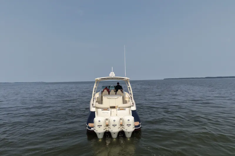 Slide: The Image of 2016 Chris-Craft Launch 36 boat on open water, rear view with triple engines. - 3