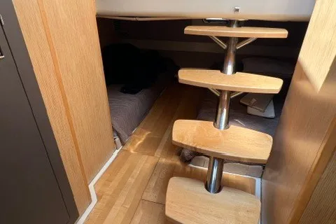 Slide: The Image of 2016 Chris-Craft Launch 36 cabin interior with wooden steps and cozy sleeping area. - 29