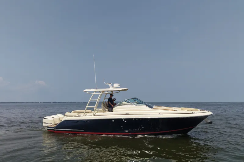 The Image of 2016 Chris-Craft Launch 36 boat cruising on open water under clear skies. - 0