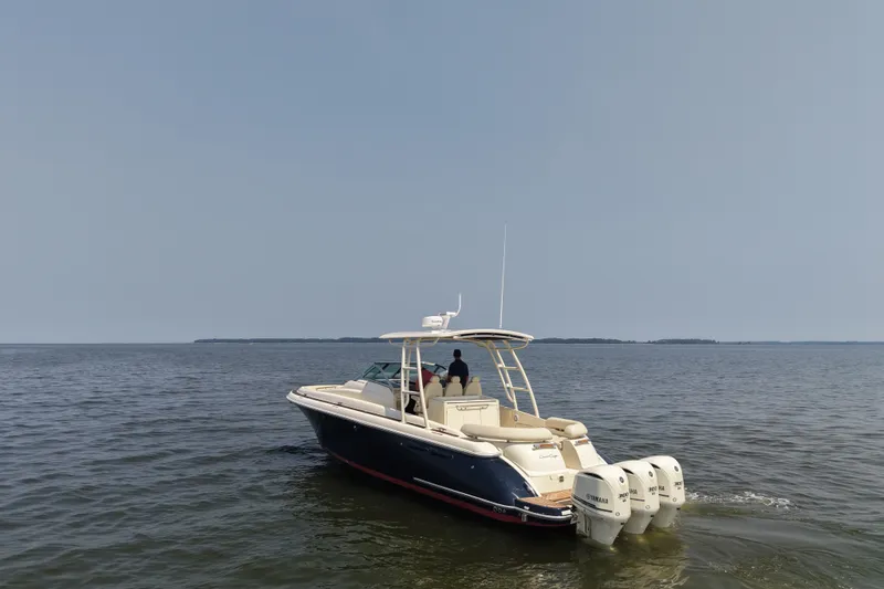 Slide: The Image of 2016 Chris-Craft Launch 36 boat cruising on open water with triple Yamaha engines. - 9