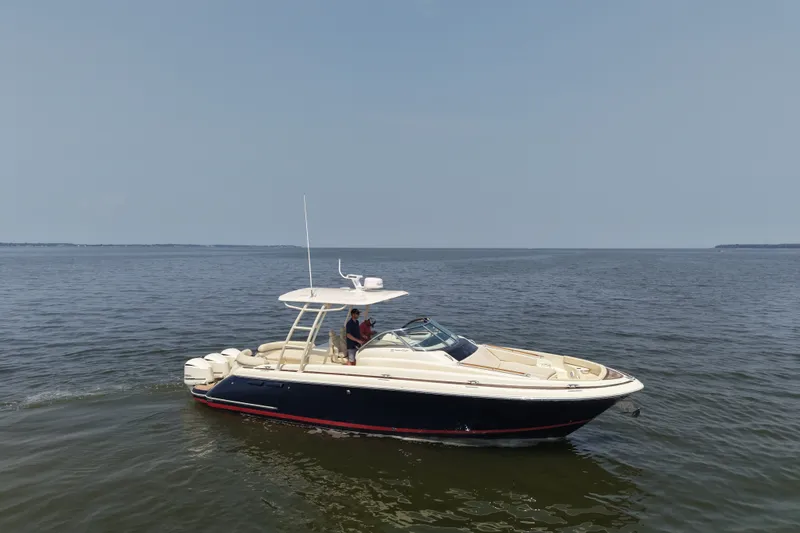 Slide: The Image of 2016 Chris-Craft Launch 36 boat cruising on open water under clear skies. - 11