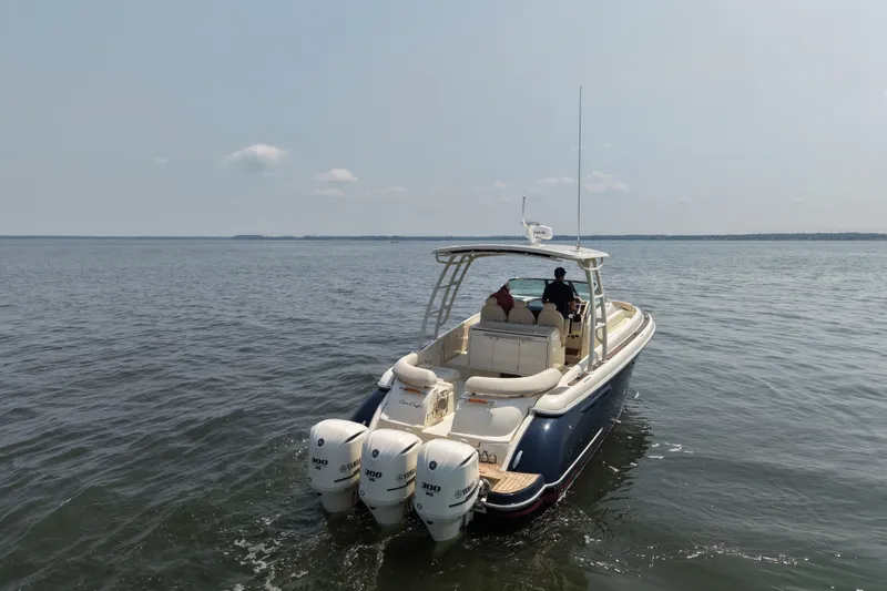 Slide: The Image of 2016 Chris-Craft Launch 36 boat cruising on open water with triple Yamaha engines. - 14
