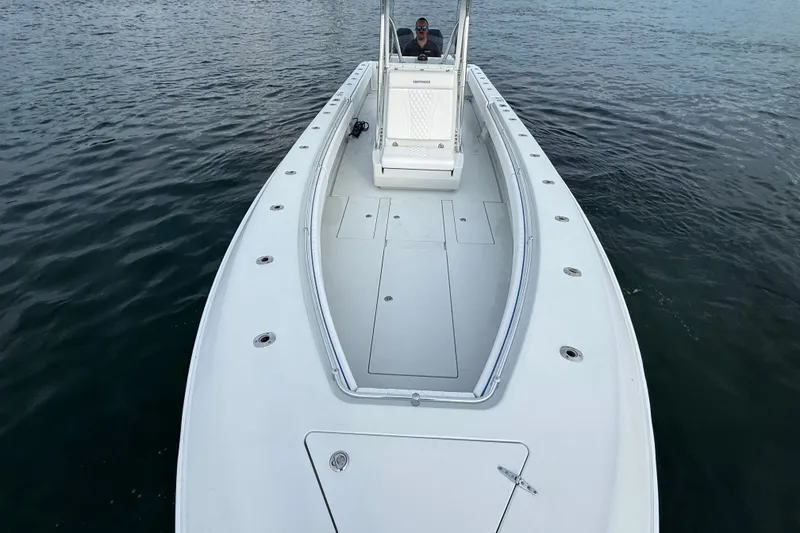 Slide: The Image of 2011 Contender 35 ST boat on water, showcasing spacious deck and sleek design. - 7