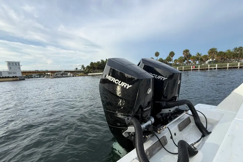 Slide: The Image of Twin Mercury outboard engines on a 2011 Contender 35 ST boat, near a scenic waterfront. - 20