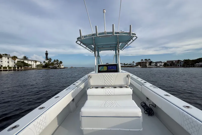 Slide: The Image of 2011 Contender 35 ST boat on calm water, featuring a sleek design and modern console. - 19