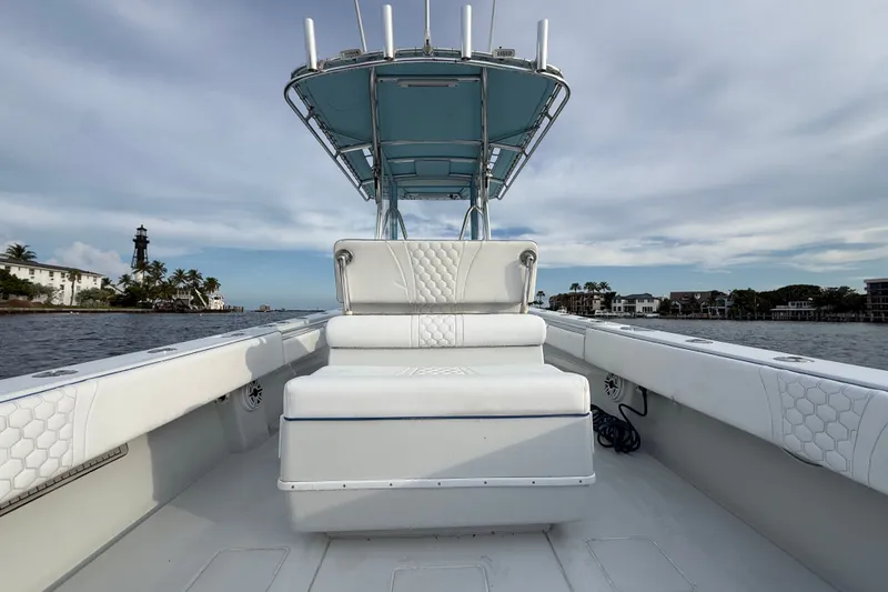 Slide: The Image of 2011 Contender 35 ST boat with white seating, ocean view, and lighthouse in the background. - 18