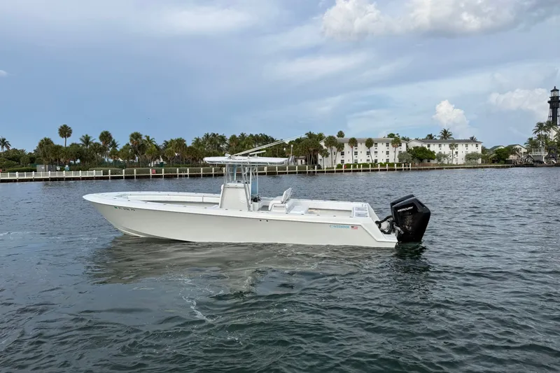 Slide: The Image of 2011 Contender 35 ST boat on calm water with scenic shoreline background. - 1